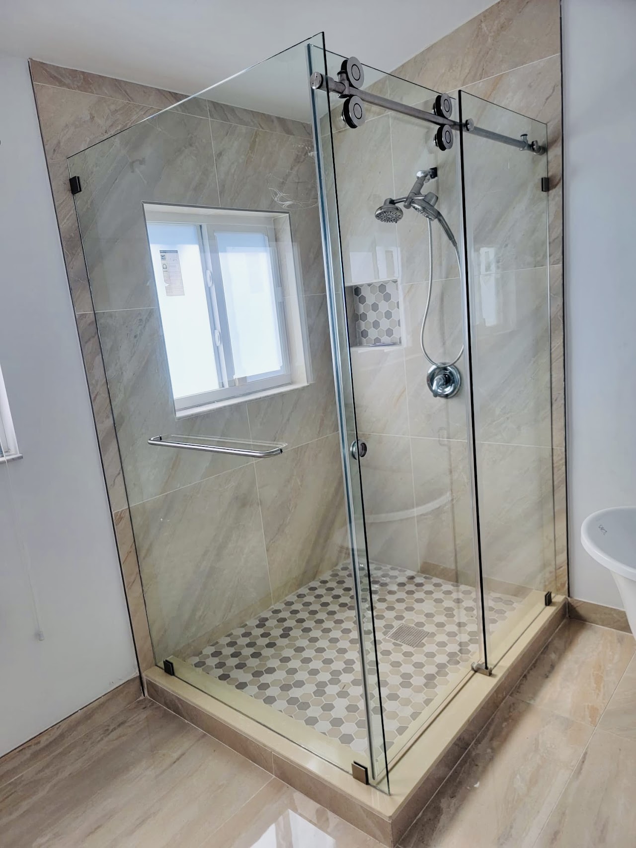 Custom frameless glass shower enclosure installed by Contis Glass